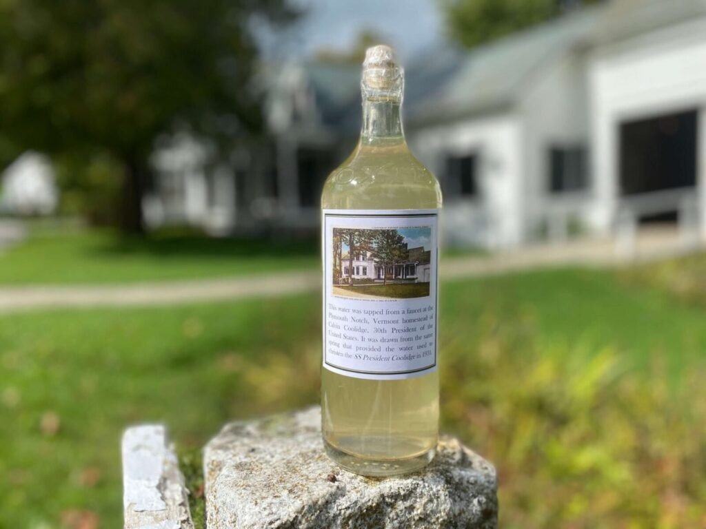 Bottle of water from Coolidge's Vermont spring, with label showing his homestead.