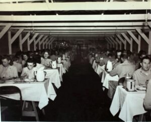 25th Infantry Division soldiers dining in a mess hall during WWII.