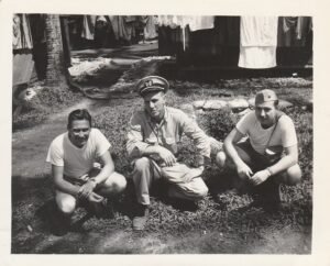 Three men in military uniforms pose outdoors, part of the 25th Infantry Division.