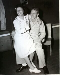 Historical photo of a smiling couple in uniform