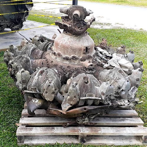 Worn radial aircraft engine on a wooden pallet outdoors