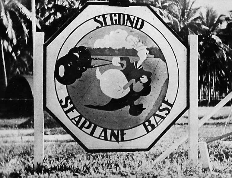Octagonal sign for Second Seaplane Base with cartoon pilot parachuting