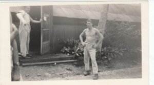 25th Infantry Division soldiers outside a building, one shirtless
