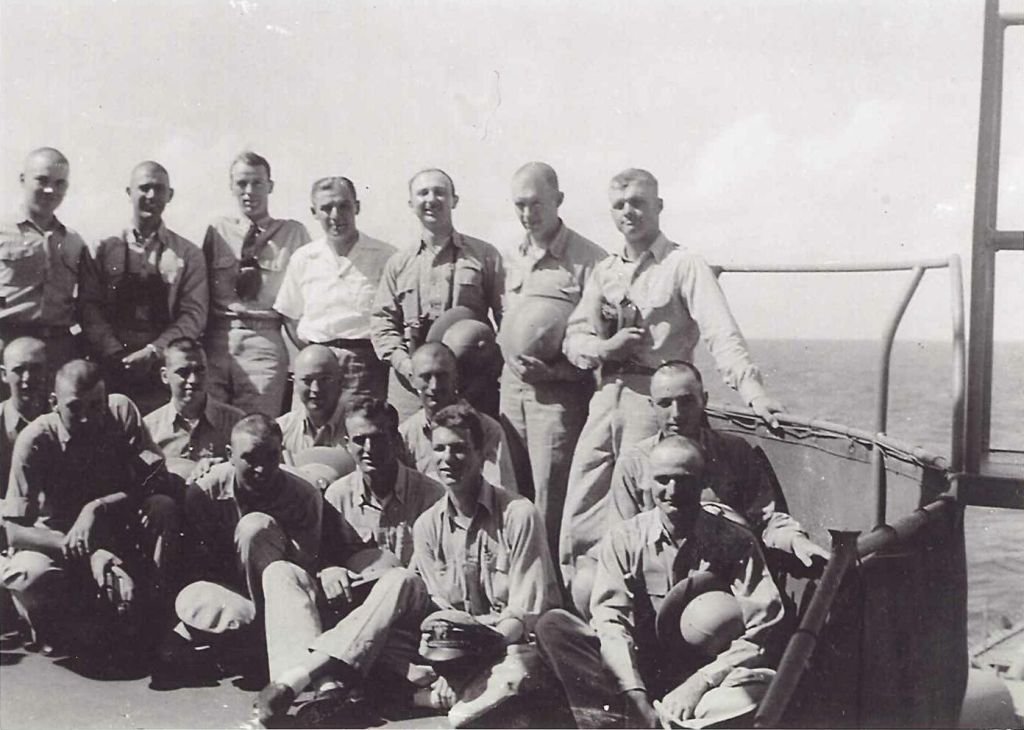 Group portrait of sailors in uniform on a ship deck