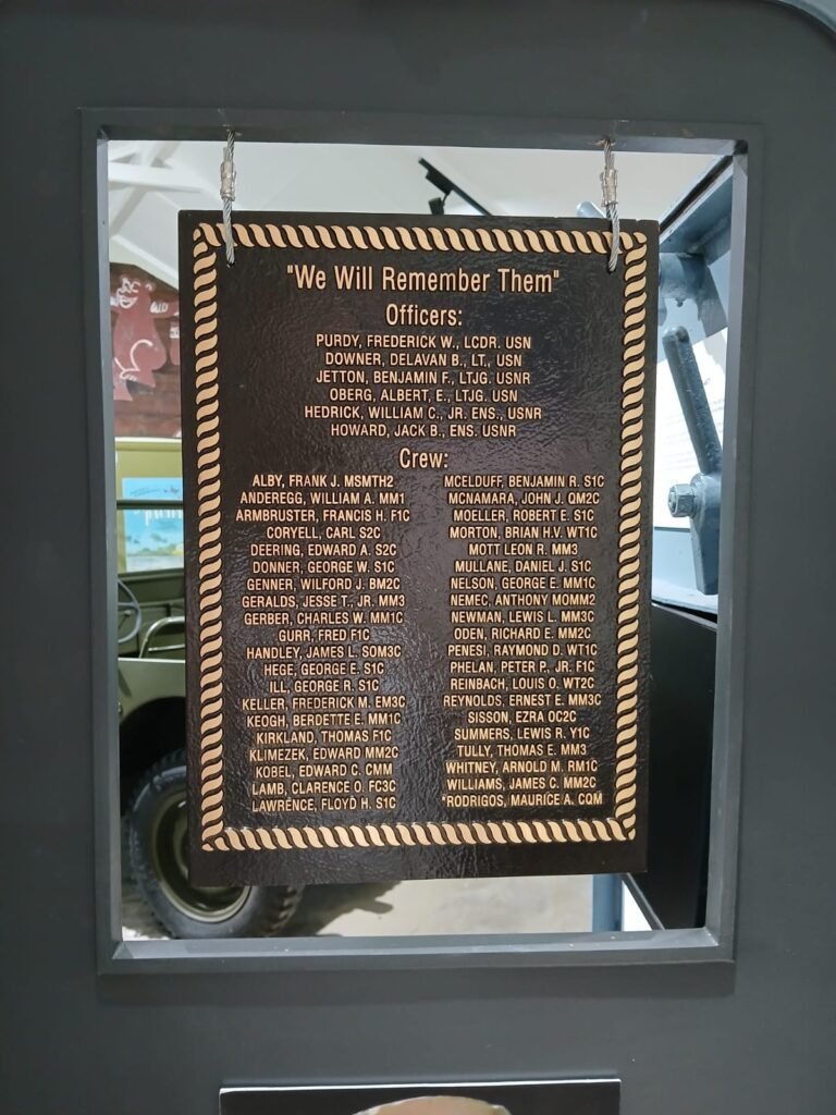 Memorial plaque lists "We Will Remember Them" officers and crew